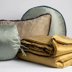 Folded Paloma Bed End Blanket from Bella Notte Linens in the color Honeycomb displayed with various Paloma Throw Pillows in various colors from Bella Notte Linens.